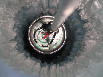A DOM seen from above as it descends into the array where it can start taking data. (Mark Krasberg, IceCube/NSF)