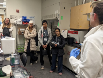 Graduate student Katherine Powell gives a tour of the Curtis Cell Physics lab during CUWiP.
